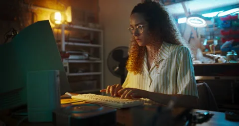 Female Hispanic Developer Using Computer In Retro Garage Stock Footage 256000021