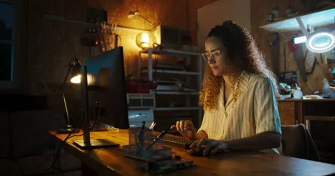 Female Hispanic Developer Using Computer In Garage Stock Footage 256000176