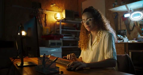 Female Hispanic Developer Using Computer In Garage 動画素材 256000224