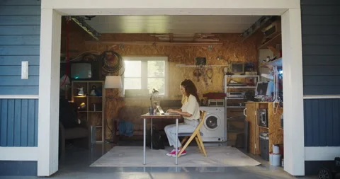 Female Hispanic Developer Using Laptop In Retro Garage Stock Footage 255996785