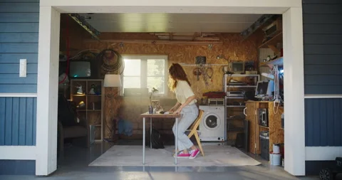 Female Hispanic Developer Using Laptop In Retro Garage 動画素材 255996815