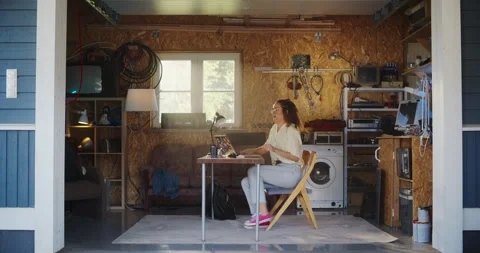 Female Hispanic Developer Using Laptop In Retro Garage 動画素材 255996846