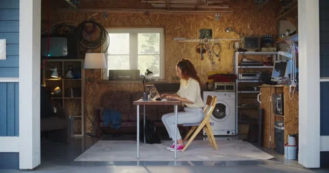 Female Hispanic Developer Using Laptop In Retro Garage Stock Footage 255996861