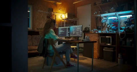 Female Hispanic Programmer Using Computer In Garage Stock Footage 256000257