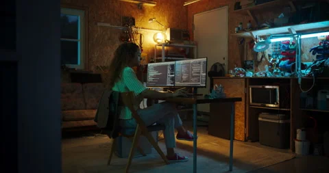 Female Hispanic Programmer Using Computer In Garage Stock Footage 256000277