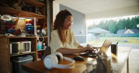 Female Hispanic Software Developer Using Laptop In Garage Stock Footage 255998187