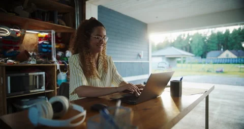 Female Hispanic Software Developer Using Laptop In Garage Stock Footage 255998200