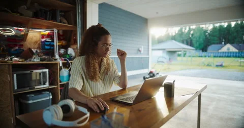 Female Hispanic Software Developer Using Laptop In Garage Stock Footage 255998223