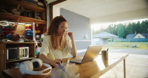 Female Hispanic Software Developer Using Laptop In Garage Stock Footage 255998233