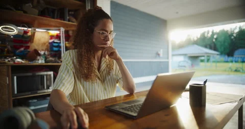 Female Hispanic Software Developer Using Laptop In Garage Stock Footage 255998241
