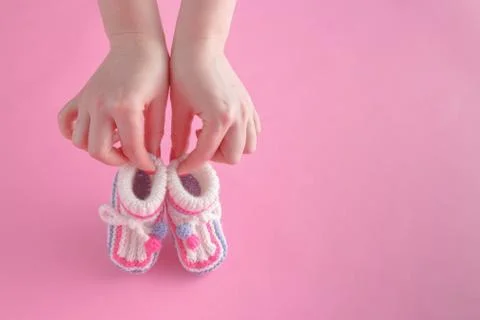 Female hold tiny newborn booties Stock Photos