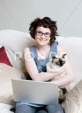 Female Holding A Cat And A Laptop