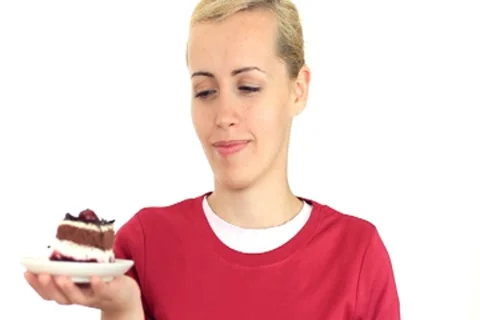 Female holding plate with tasty cake and apple, isolated on white NTSC wide Stock Footage