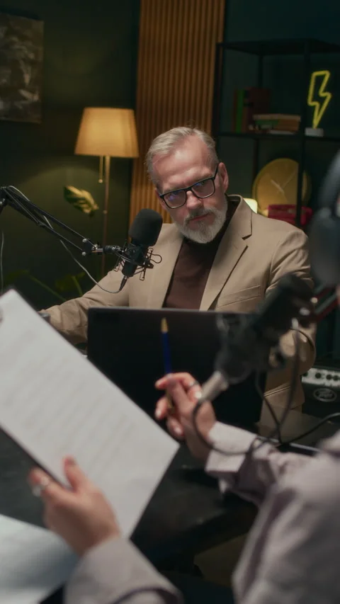 Female Host Reading Script when Communicating with Mature Man during Podcast Stock Footage 309322456