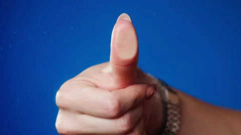 Female human hand making thumb fingerprint on blue background. Person pressing Stock Footage 162671561