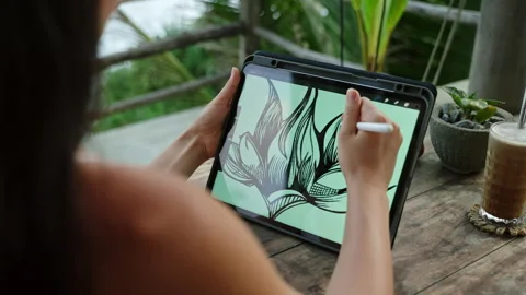 Female illustrator hands draw on tablet at cafe with ocean view, palm trees Stock Footage 254338289