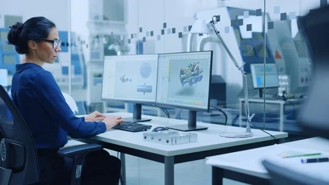 Female Industrial Engineer Solving Problems, Working on a Personal Computer Stock Footage 123634063