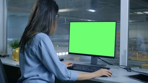 Female Industrial Engineer Works on Her Computer with  Mock-up Green Screen.  Stock Footage