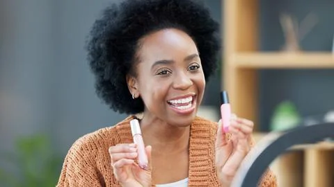 A female influencer recording a makeup tutorial for her beauty blog or live Stock Photos