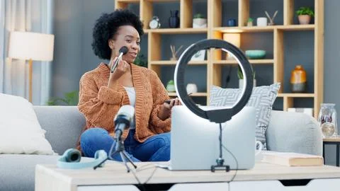 A female influencer recording a makeup tutorial for her beauty blog or live Stock Photos