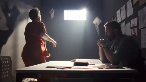 Female Inmate Throwing Papers and Yelling at Investigator during Interrogation Stock Footage 311202553