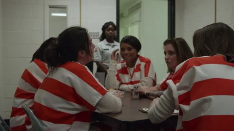 Female Inmates Are Playing Cards In Pris 