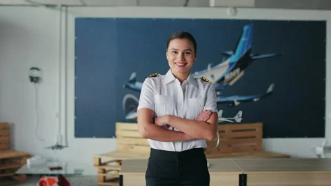 Female instructor, pilot standing in classroom, looking at camera, smiling. Stock Footage 234517755