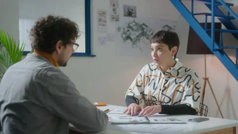 Female Interior Designer and Client Discussing Sketch in the Office Stock Footage 248237023