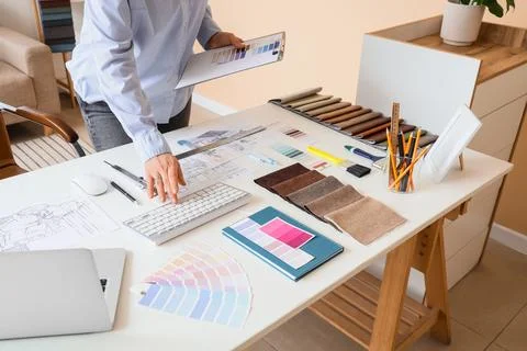Female interior designer working with computer at table in office 스톡 사진