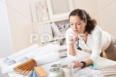 Female interior designer working at office Stock-Fotos