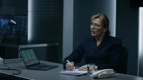 Female Interrogation Expert Conducts Lie Detector / Polygraph Test on a Suspect 動画素材 94569322