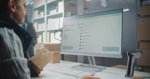 Female Inventory Manager Scans Code. Computer Screen Shows Delivery Tracking Stock Footage 307662675