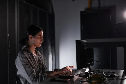 Female IT Engineer in Dark Server Room Stock Photos