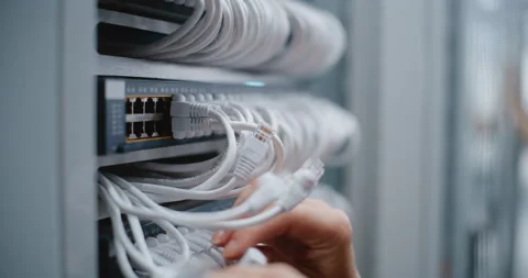 Female IT Engineer Inspecting Server Rack Cabling and Ethernet Connections Stock Footage 344966334