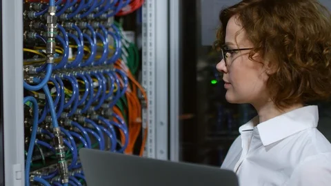 Female IT Engineer Working on Laptop in Server Room Stock Footage 101966843