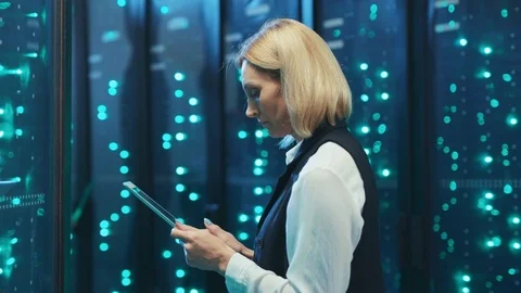 Female IT server specialist cooperating in digital high tech room of data center Stock Footage 120482099