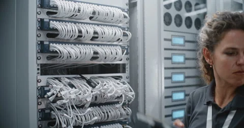 Female IT Specialist Installing New Network Switch During Infrastructure Upgrade 動画素材 344967816