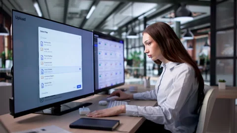 Female IT Specialist Managing Secure Cloud Data Transfer Stock Footage 334533758