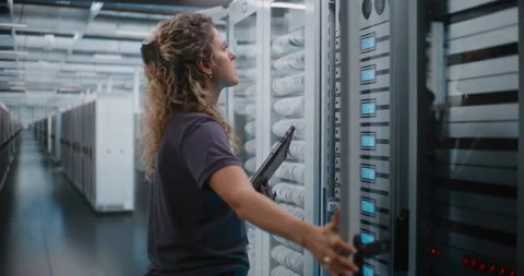 Female IT Specialist Using Digital Tablet near Open Server Cabinet Vídeo Stock 344887787