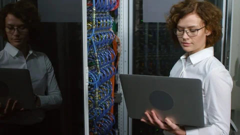 Female IT Specialist Using Laptop in Server Room 動画素材 101969583