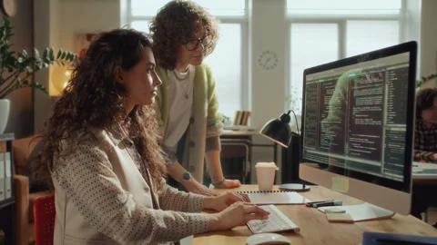 Female IT Specialists Collaborating on Software Development in Office Stock Footage 305314154