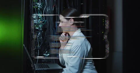Female IT tech inspecting rack LEDs, HUD updating causing typing on laptop Stock Footage 334316389