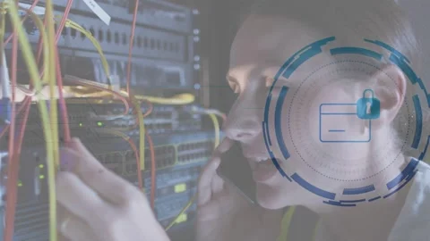 Female IT tech receiving call, adjusting patch cables at rack, security overlay Stock Footage 332613792