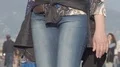Female in jeans going along street holding paper bag in hand, shopping in city HD Footage