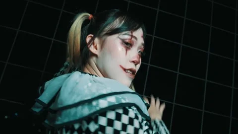 Female Jester in Clown Makeup Dancing Energetically at Night Video stock 264356399
