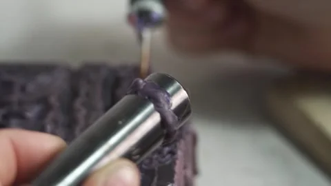 A female jeweler constructs a unique ring design using wax melting Stock Footage 277883878