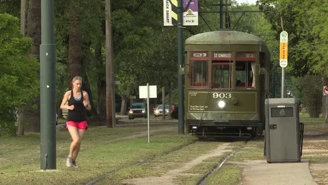 Female jogger crossing tramway while jogging Stock Footage 84513159