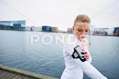 Female jogger monitor her progress on smartphone Stock Photos