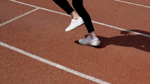 Female jogging on racetrack Stock Footage 95082832