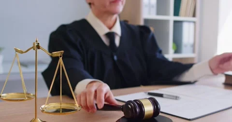 Female judge authority writing, using gavel, hammer bangs to sentence in court Stock Footage 334631346